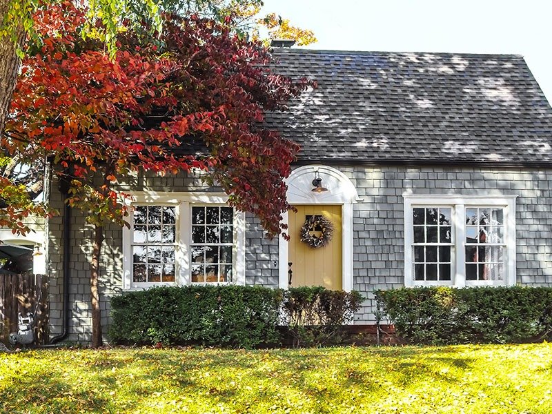 Gray home with dark Cedar Shakes roof