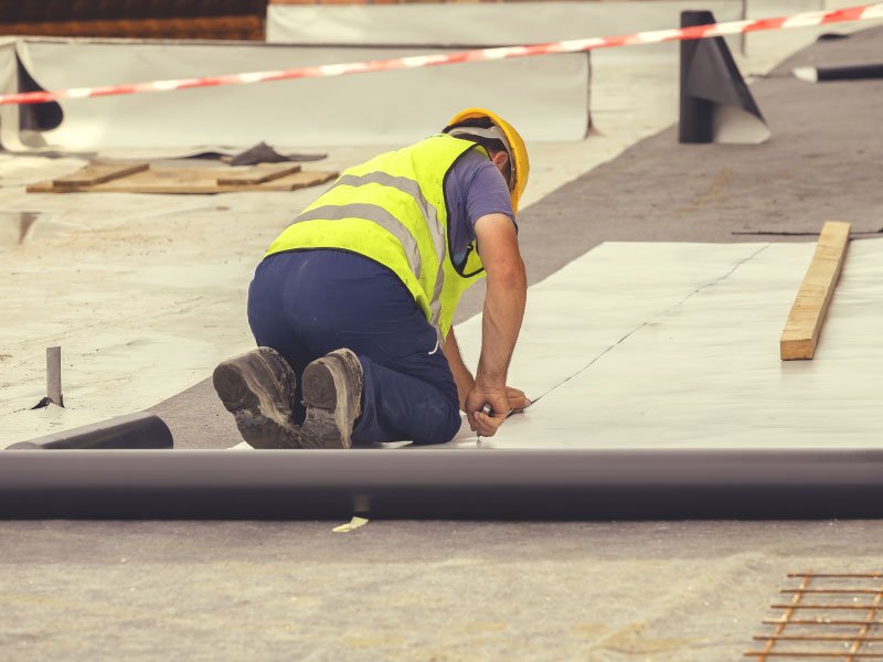 roofer installing TPO single ply on a commercial roof